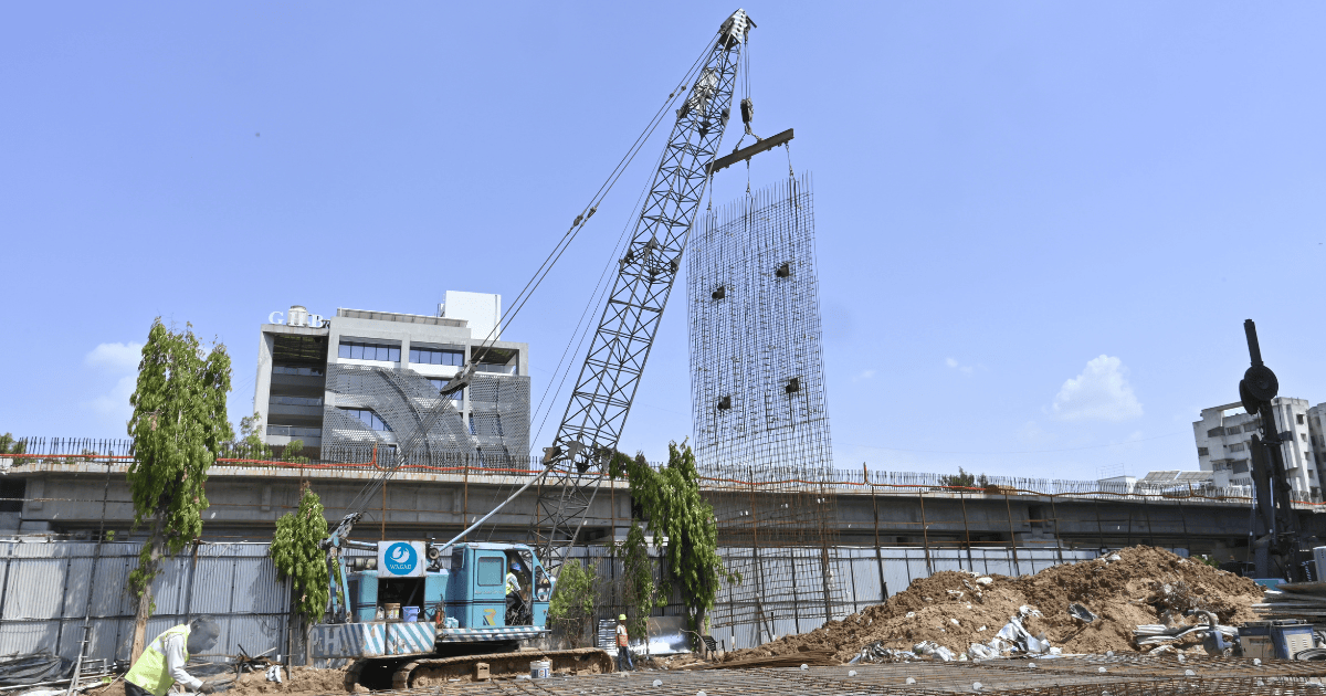 Construction crew excavating a deep trench for diaphragm wall installation