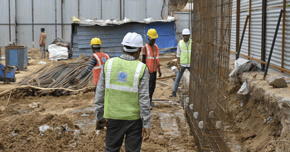 Construction site with workers and heavy machinery for diaphragm wall engineering